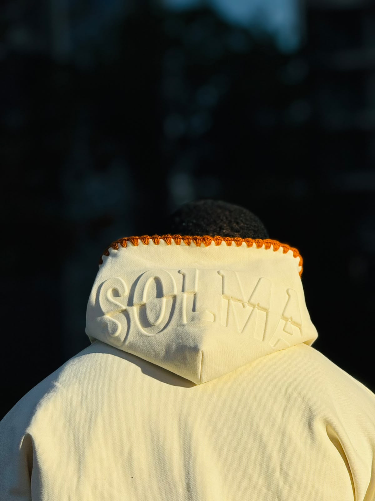 Back of the hood — the debossed SOLMA serif